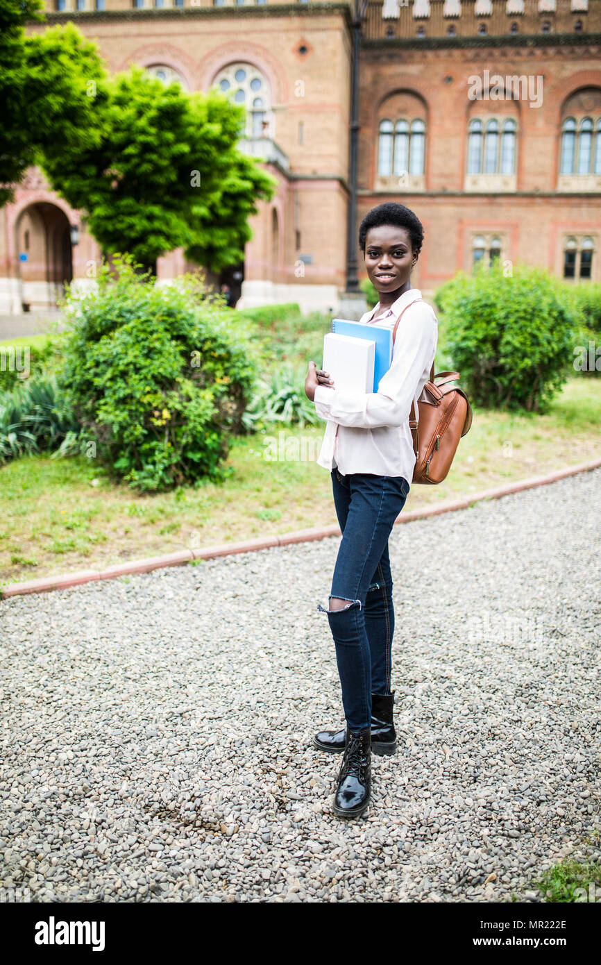 happy african college girl outdoors on modern campus Stock Photo - Alamy