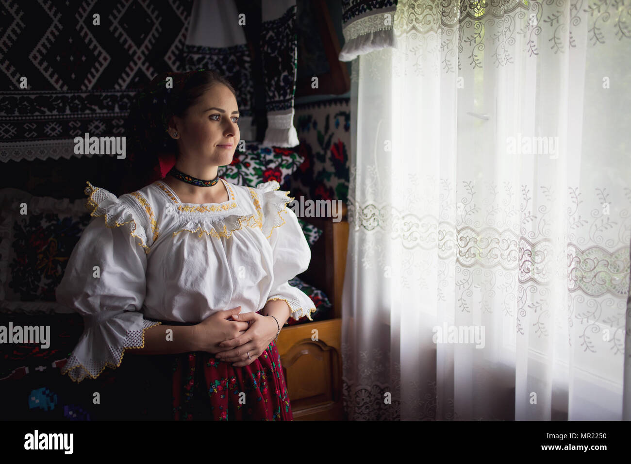 Portrait of a beautiful young woman wearing traditional Romanian clothes, in Maramures Stock Photo