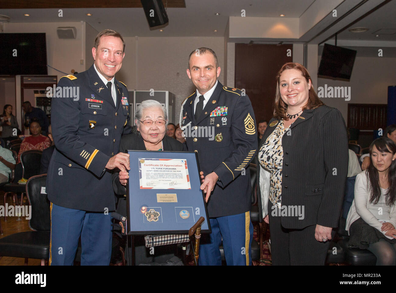 Yukie Furukawa, named Outstanding Volunteer of the Year, receives a plaque during Camp Zama's annual Volunteer Recognition Ceremony April 21 at the Camp Zama Community Club. (U.S. Army photo by Honey Nixon) Stock Photo