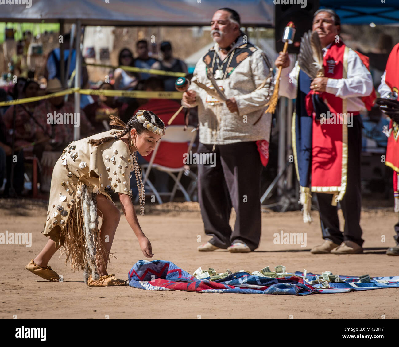 A young Chumash Native American girl is donating money at the annual