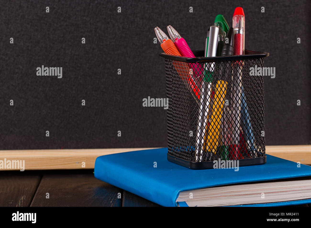 Stationery pens, pen holder, diary on a black background Stock Photo Alamy