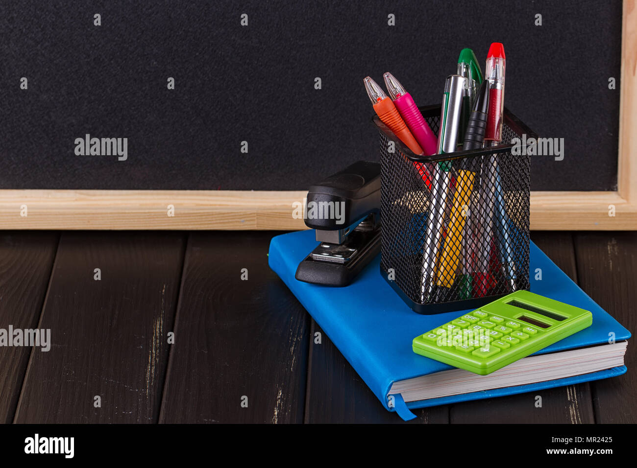 Stationery pens, pen holder, diary on a black background Stock Photo Alamy