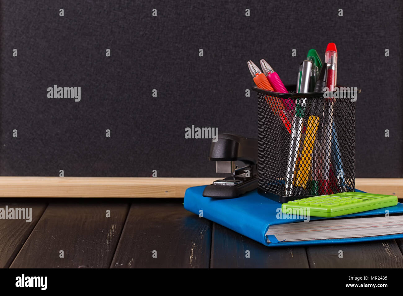 Stationery pens, pen holder, diary on a black background Stock Photo Alamy