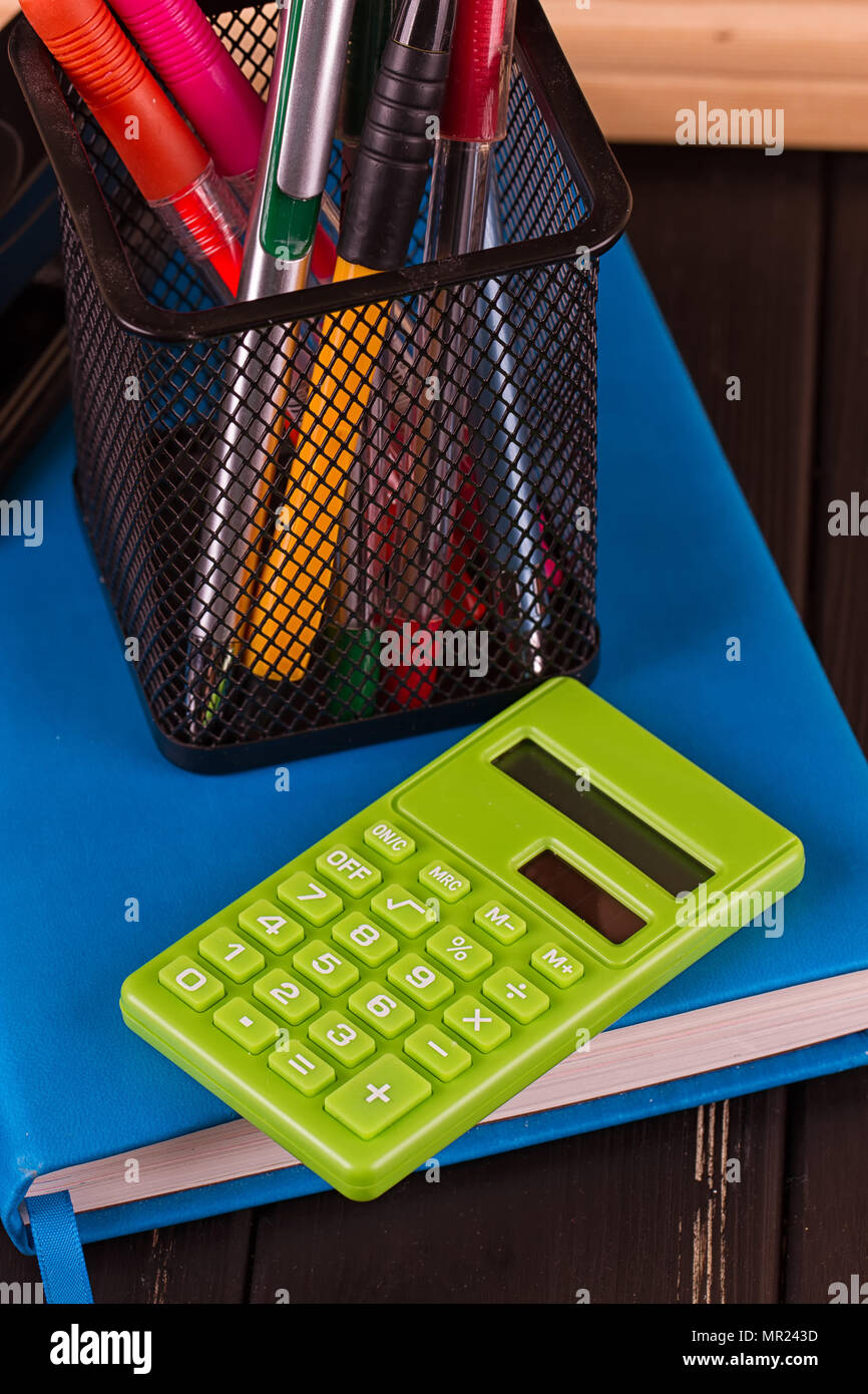 Stationery pens, pen holder, diary on a black background Stock Photo Alamy