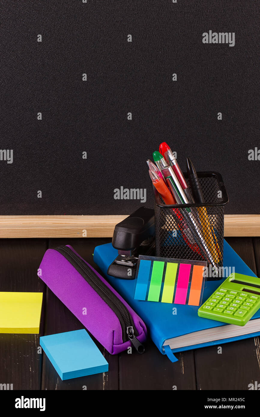 Stationery pens, pen holder, diary on a black background Stock Photo Alamy