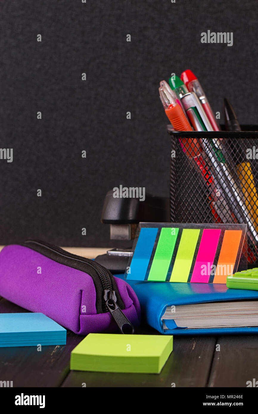 Stationery pens, pen holder, diary on a black background Stock Photo Alamy