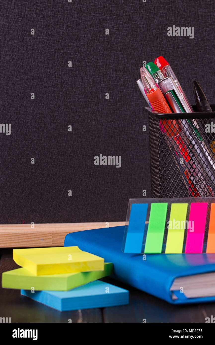 Stationery pens, pen holder, diary on a black background Stock Photo Alamy