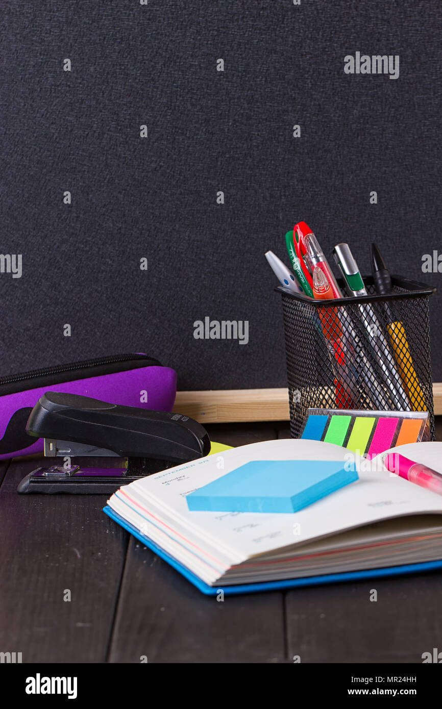 Stationery pens, pen holder, diary on a black background Stock Photo Alamy