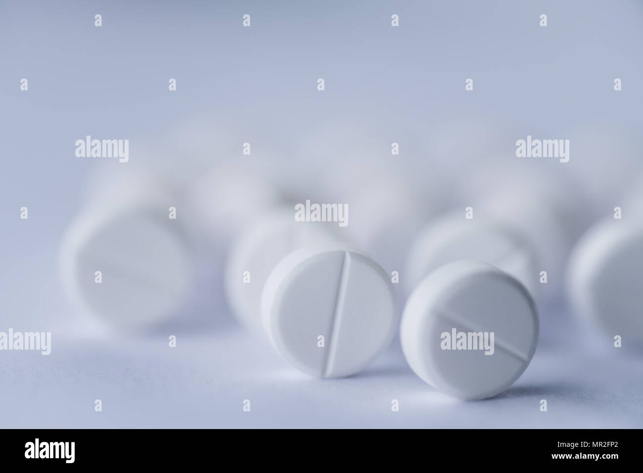 Soft focus white pills, aspirin on white background. Medical and health care concept. Stock Photo