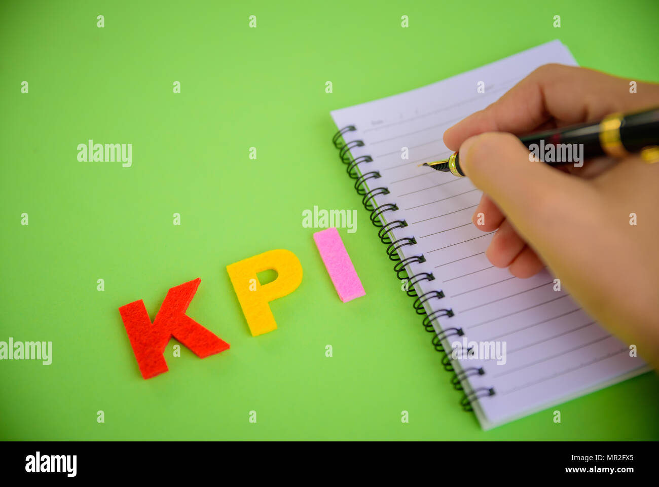 Abstract hand writing with KPI word focus ,Key Performance Indicator ...