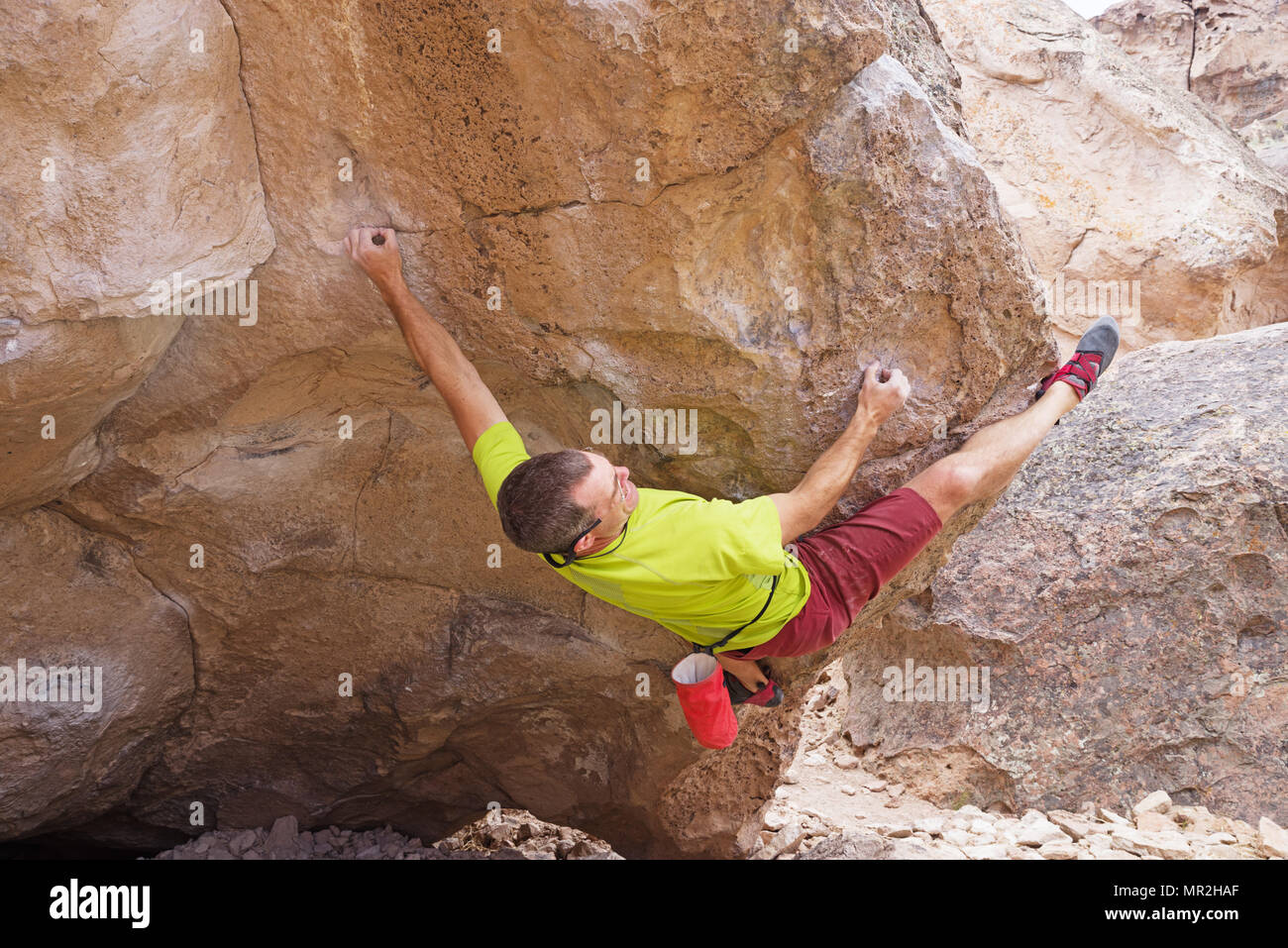 a man bouldering at the Happy Boulders in California with a