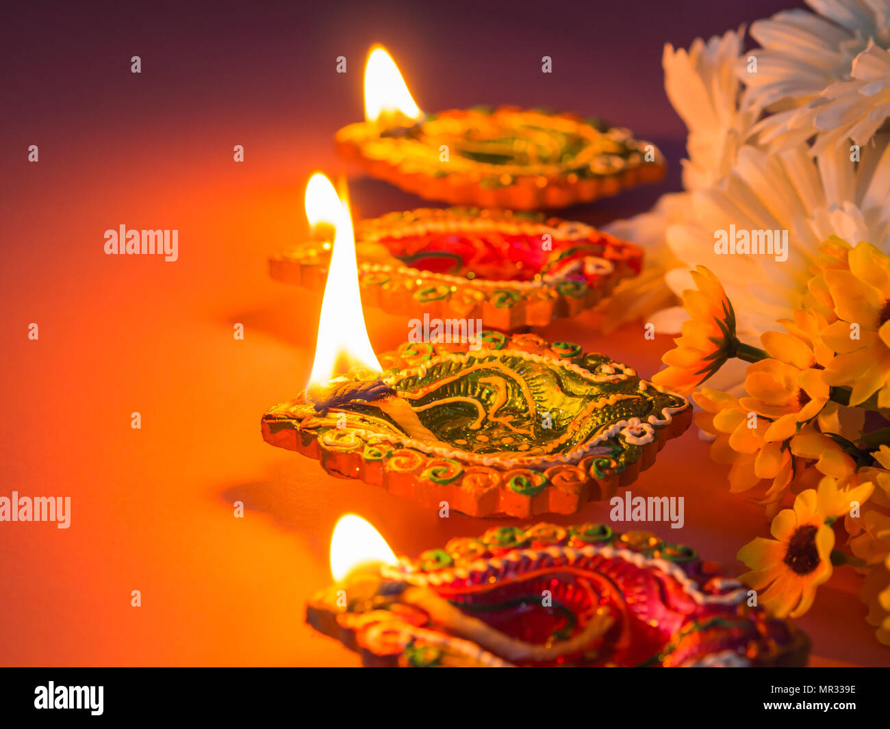 Colorful clay diya lamps lit with flowers for the Hindu Diwali festival Stock Photo - Alamy Colorful clay diya lamps lit with flowers for the Hindu Diwali festival Stock Photo - Alamy