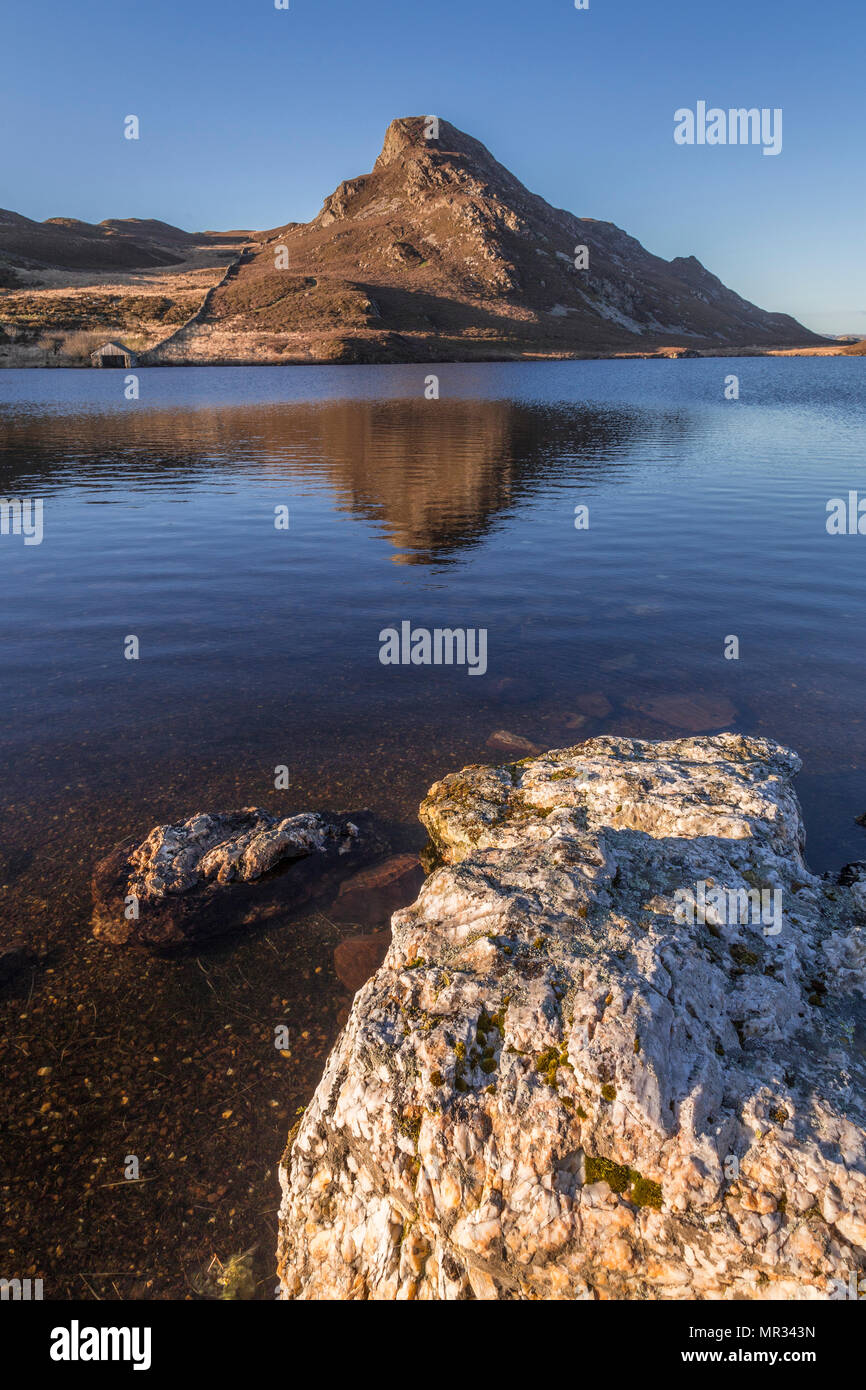 Reflection in Cregennan Lakes, Snowdonia, Wales on a sunny evening Stock Photo