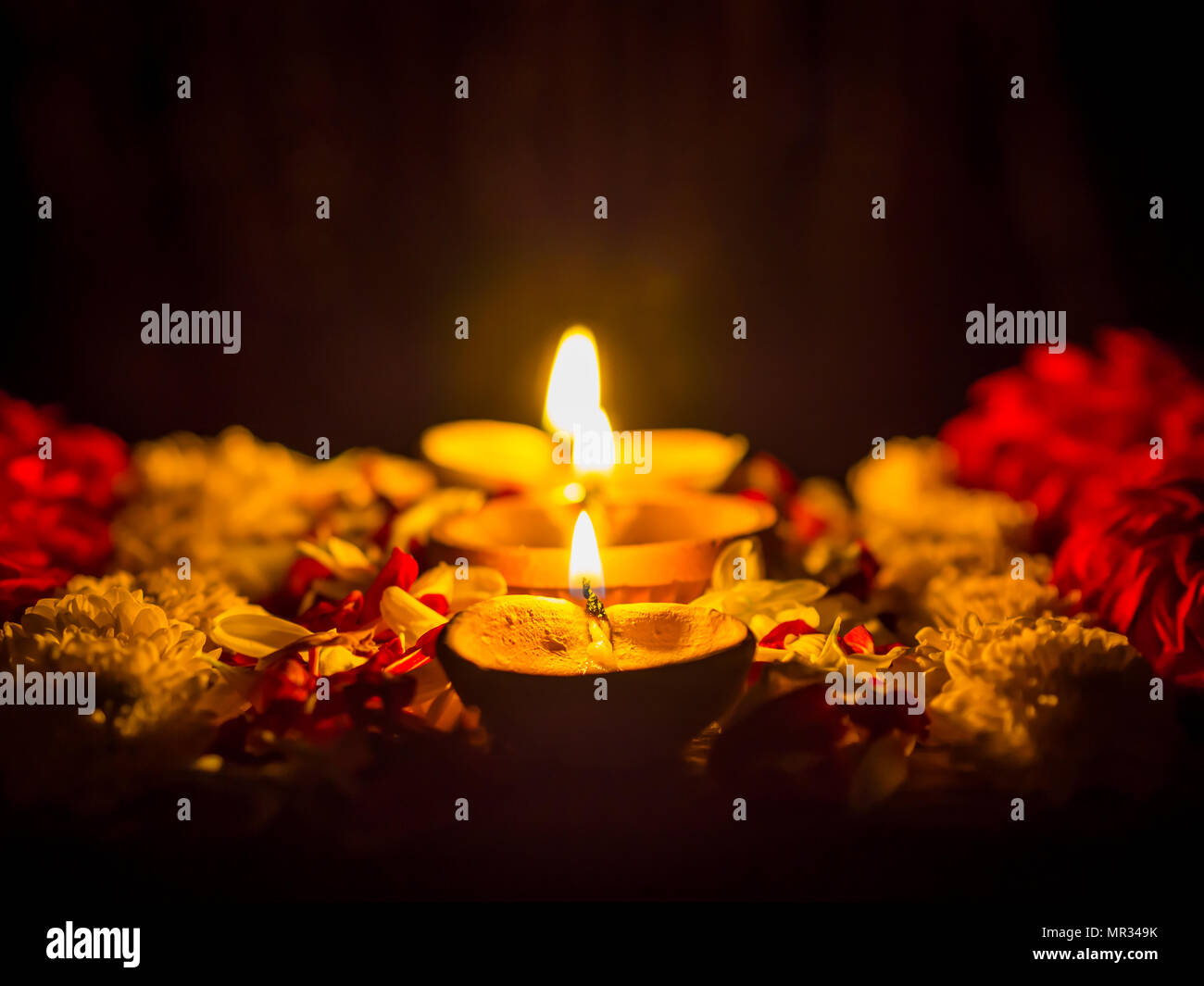 Happy Diwali - Diya lamps lit with flowers during diwali ...