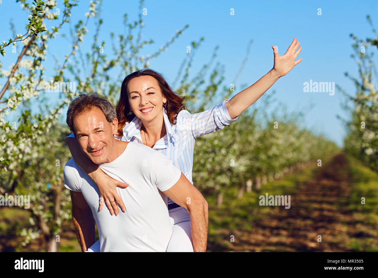 A couple is walking in the park in the summer Stock Photo - Alamy