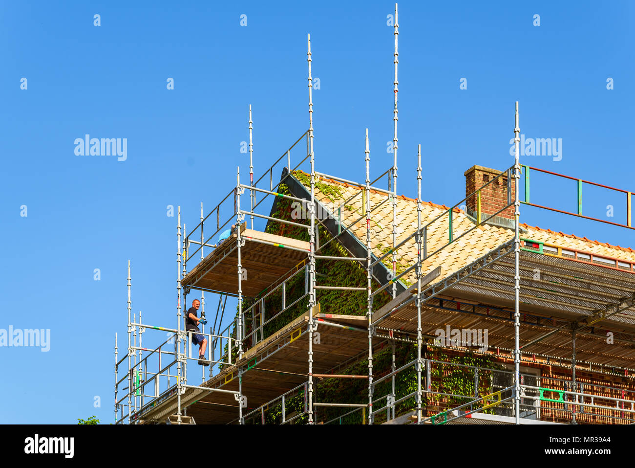 Angelholm, Sweden - May 15, 2018: Travel documentary of everyday life and place. Workers rising scaffoldings around the historical building Kronohakte Stock Photo