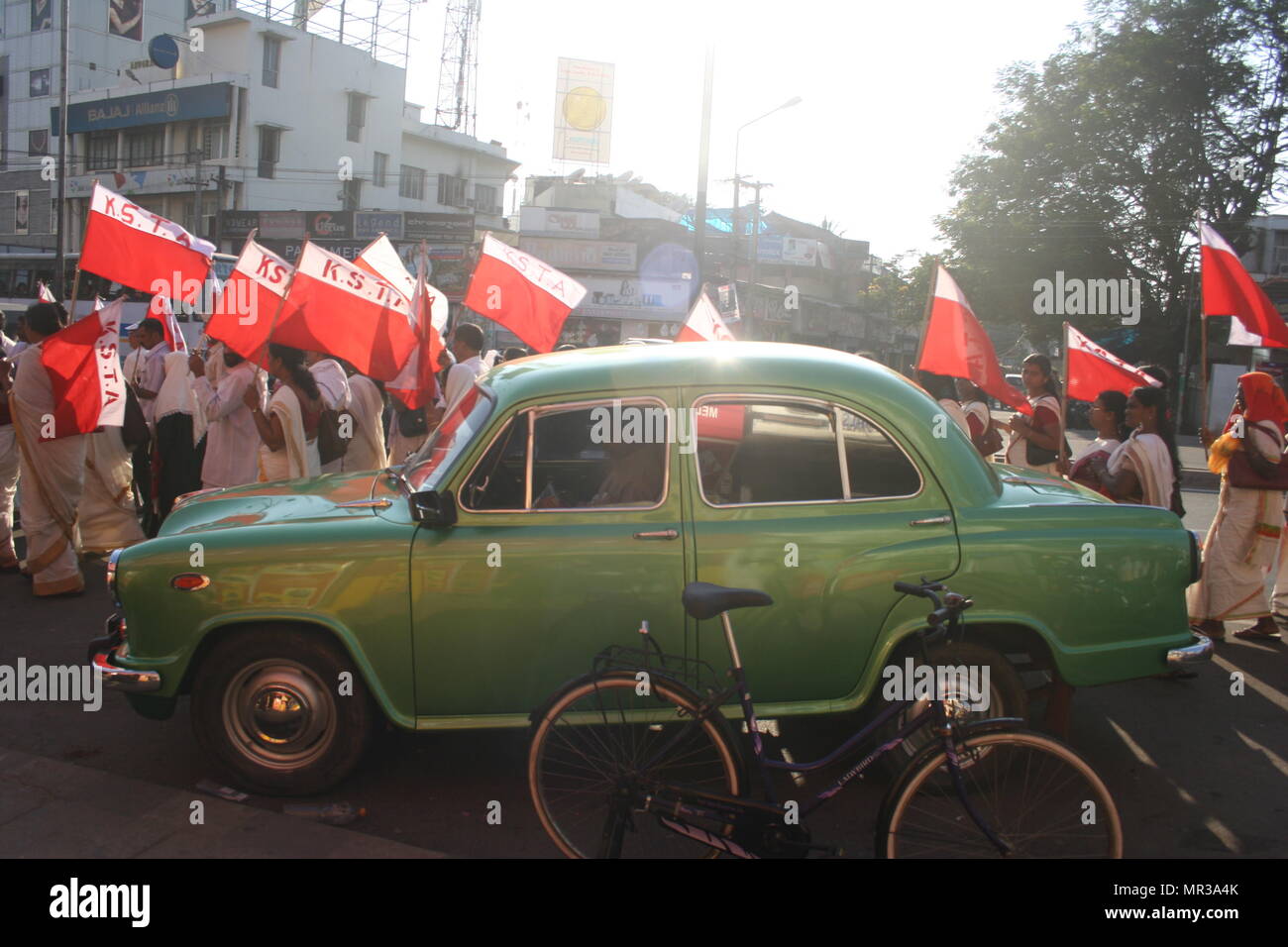 Protesters with Flags and Green Ambassador Car, Trivandrum, India Stock Photo
