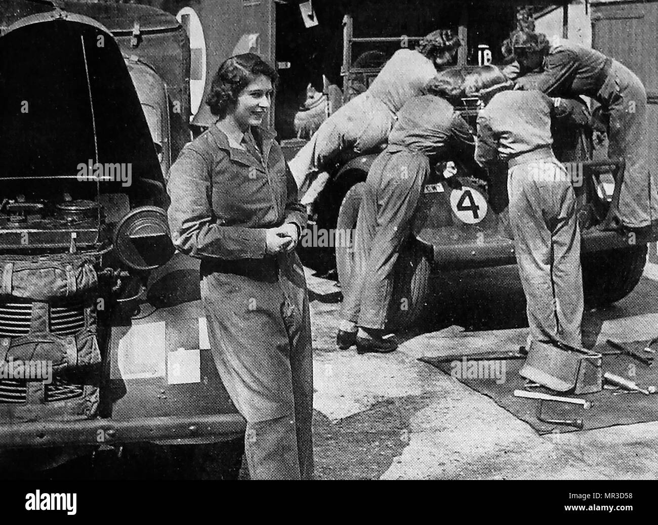 Princess Elizabeth of England (Later Queen Elizabeth II) rests whilst undertaking a WWII ATS (Auxiliary Territorial Service) car maintenance course 1946 Stock Photo