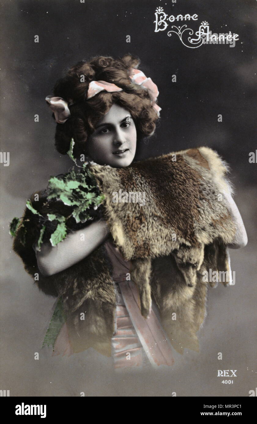 French Happy New Year, postcard depicting a woman carrying mink fur stoles. 1900 Stock Photo