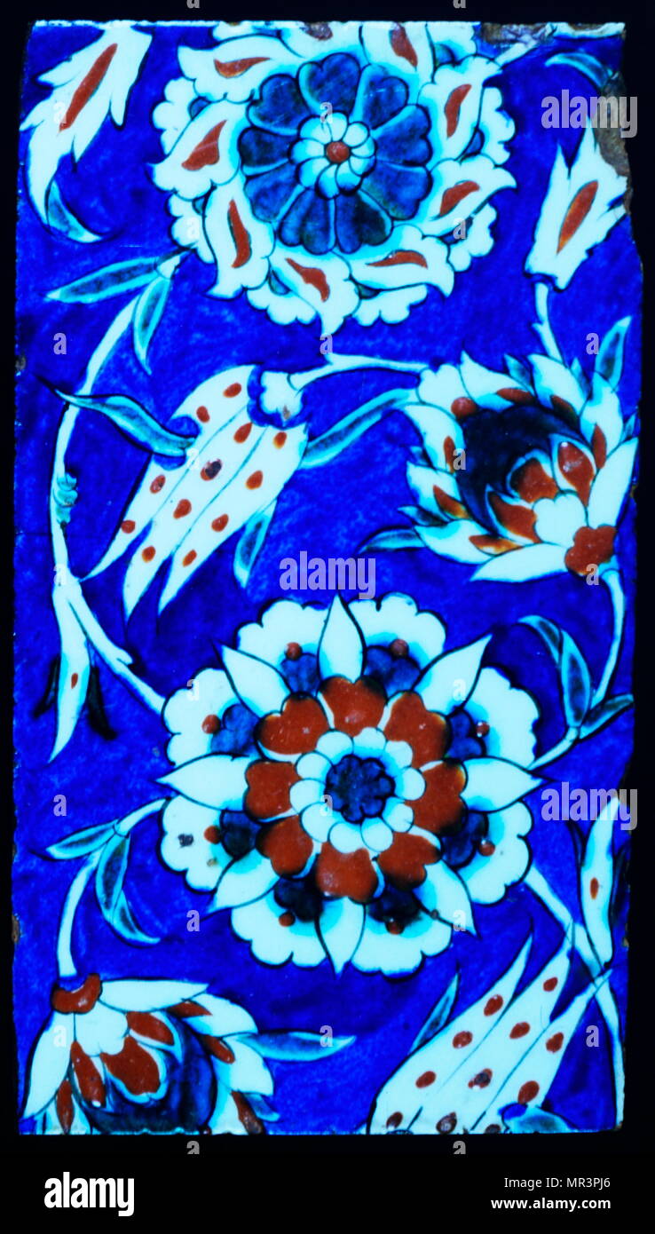 Iznik ceramic tile decorated with vines, grapes and flowers. 1573-75.  Iznik pottery, or Iznik ware, named after the town of İznik in western Anatolia (ottoman Turkey),  where it was made, is a decorated ceramic that was produced from the last quarter of the 15th century until the end of the 17th century Stock Photo