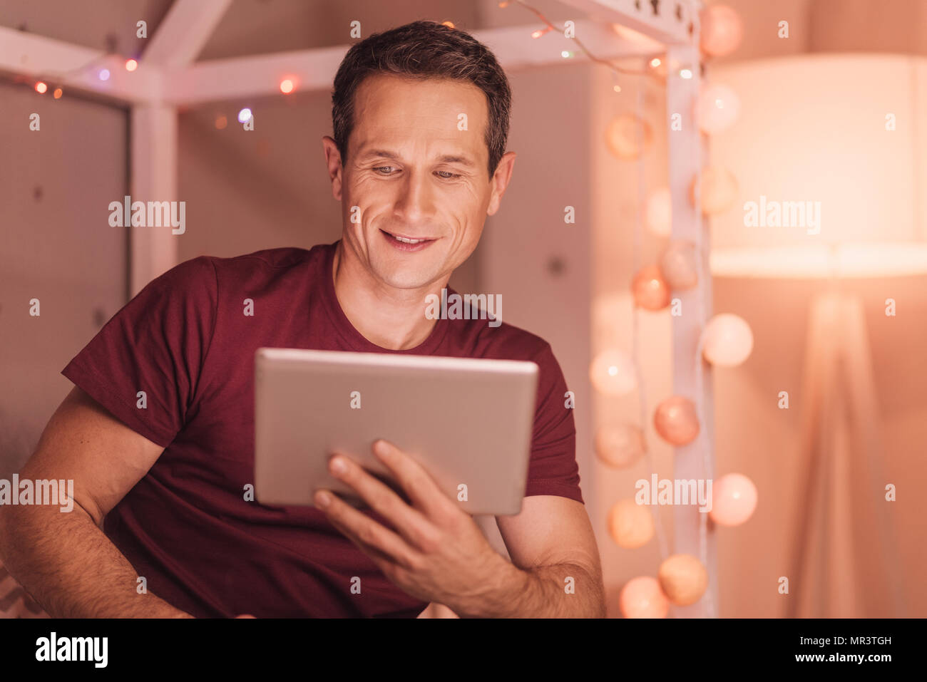 Cheerful young man looking at the tablet screen Stock Photo