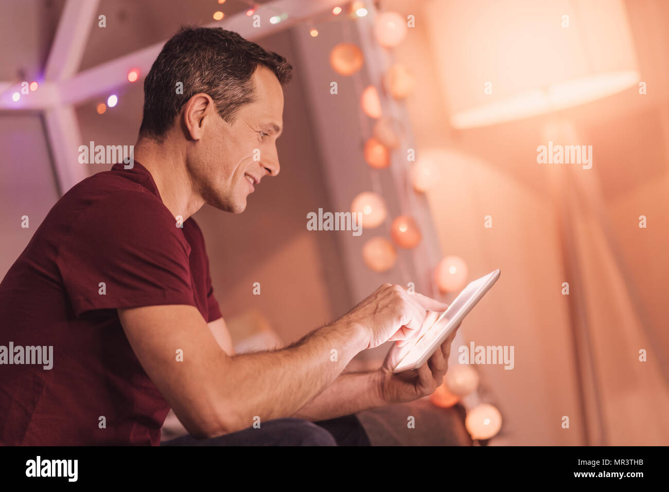 Joyful handsome man browsing the Internet Stock Photo