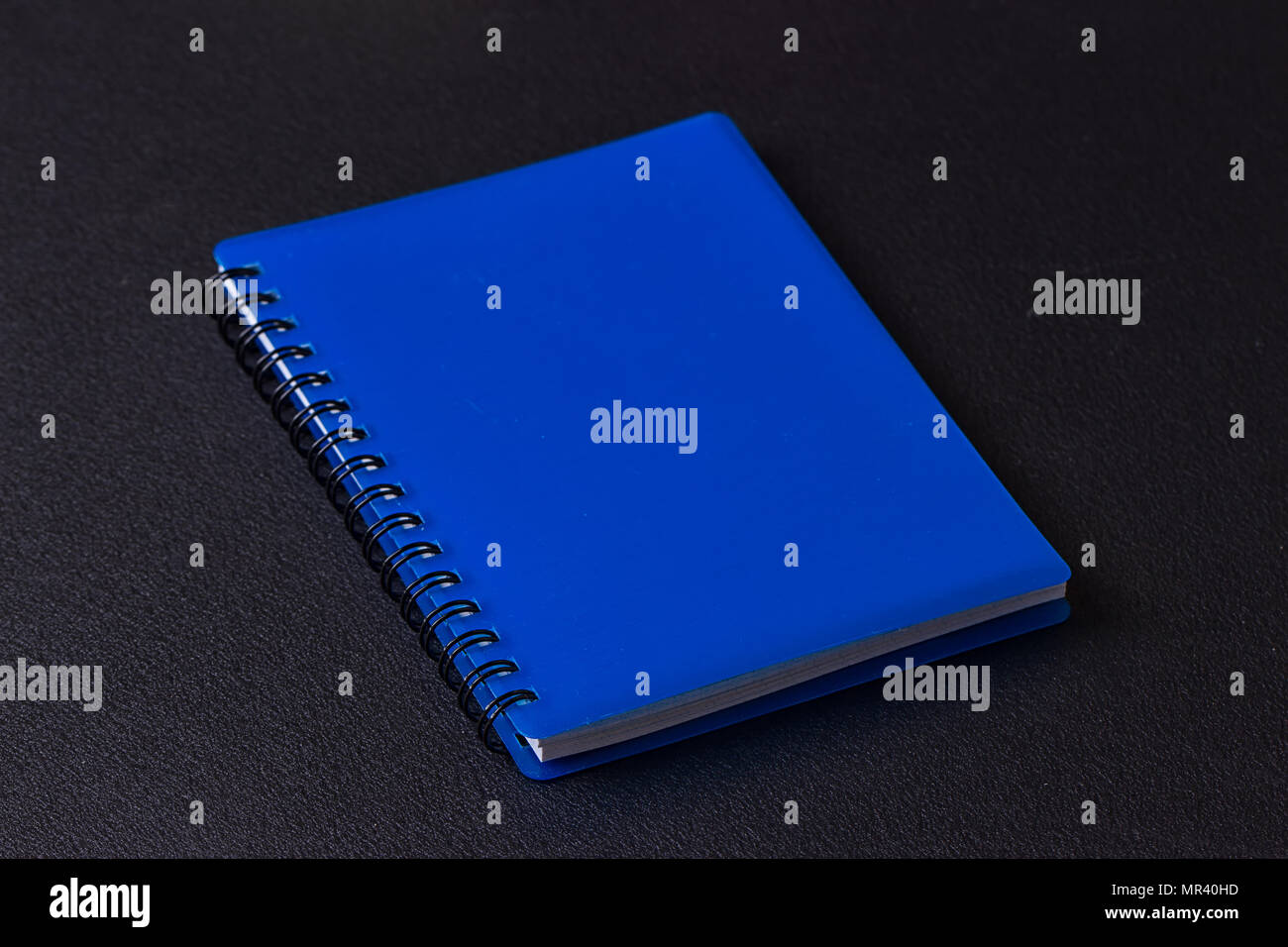 Blue notepad on a spiral on a black background Stock Photo