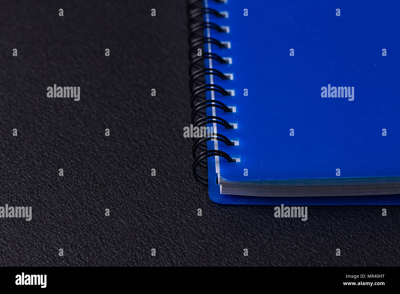 Blue notepad on a spiral on a black background Stock Photo