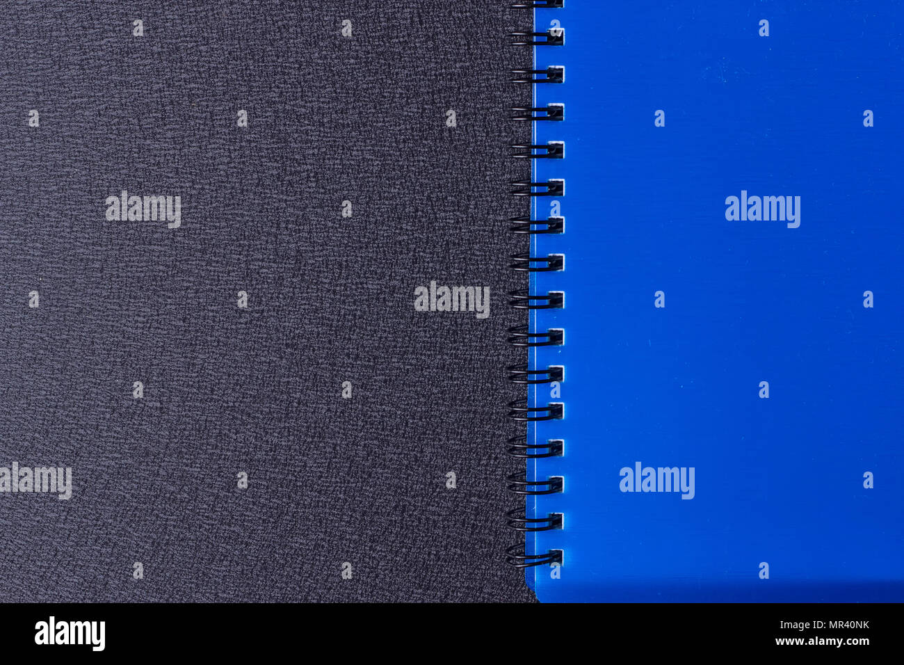 Blue notepad on a spiral on a black background Stock Photo - Alamy