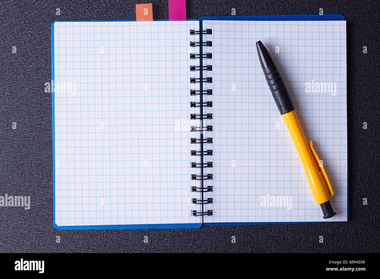 Open notepad on a spiral and pen on a black background Stock Photo