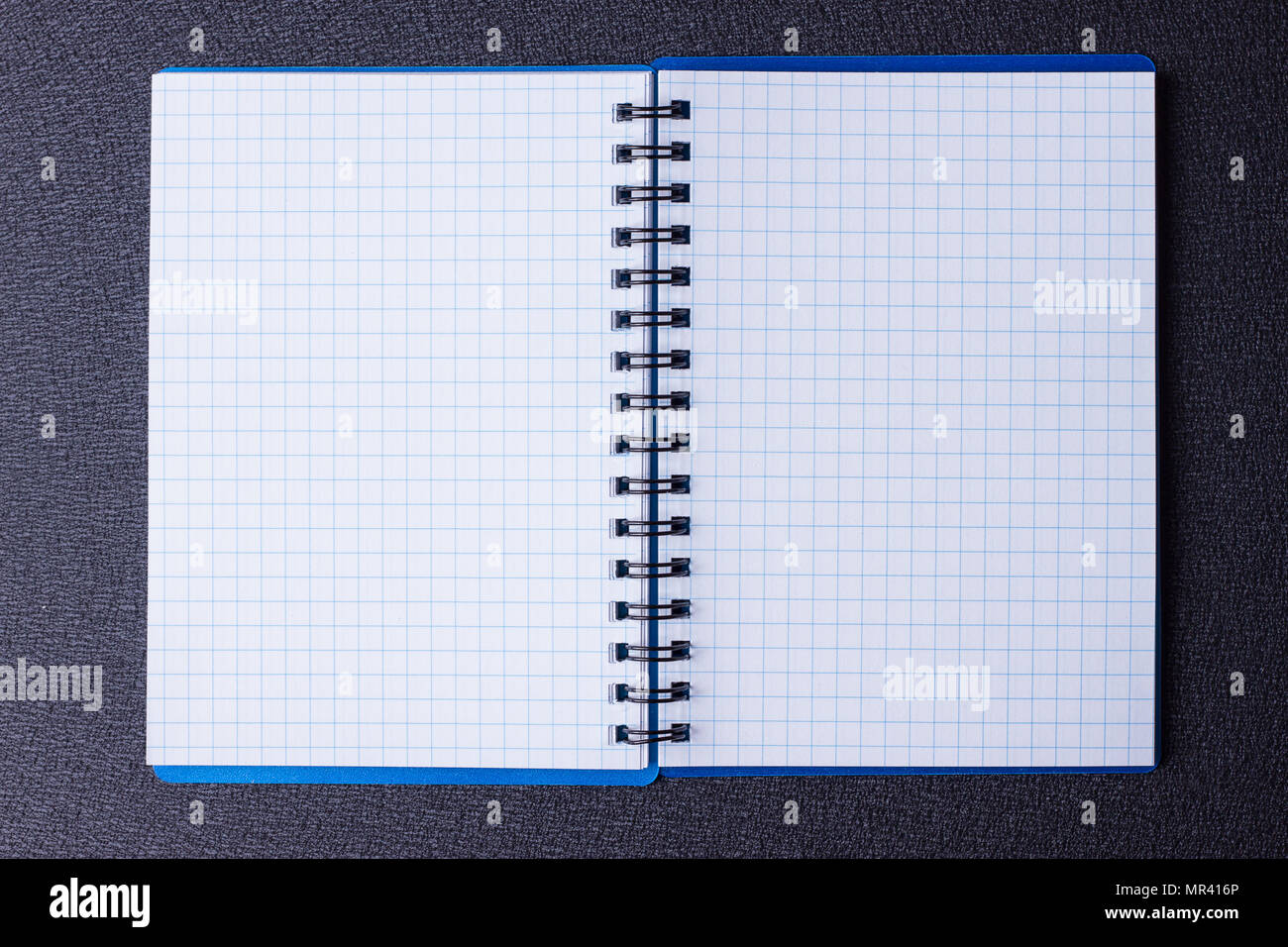 Open notepad on a spiral on a black background Stock Photo