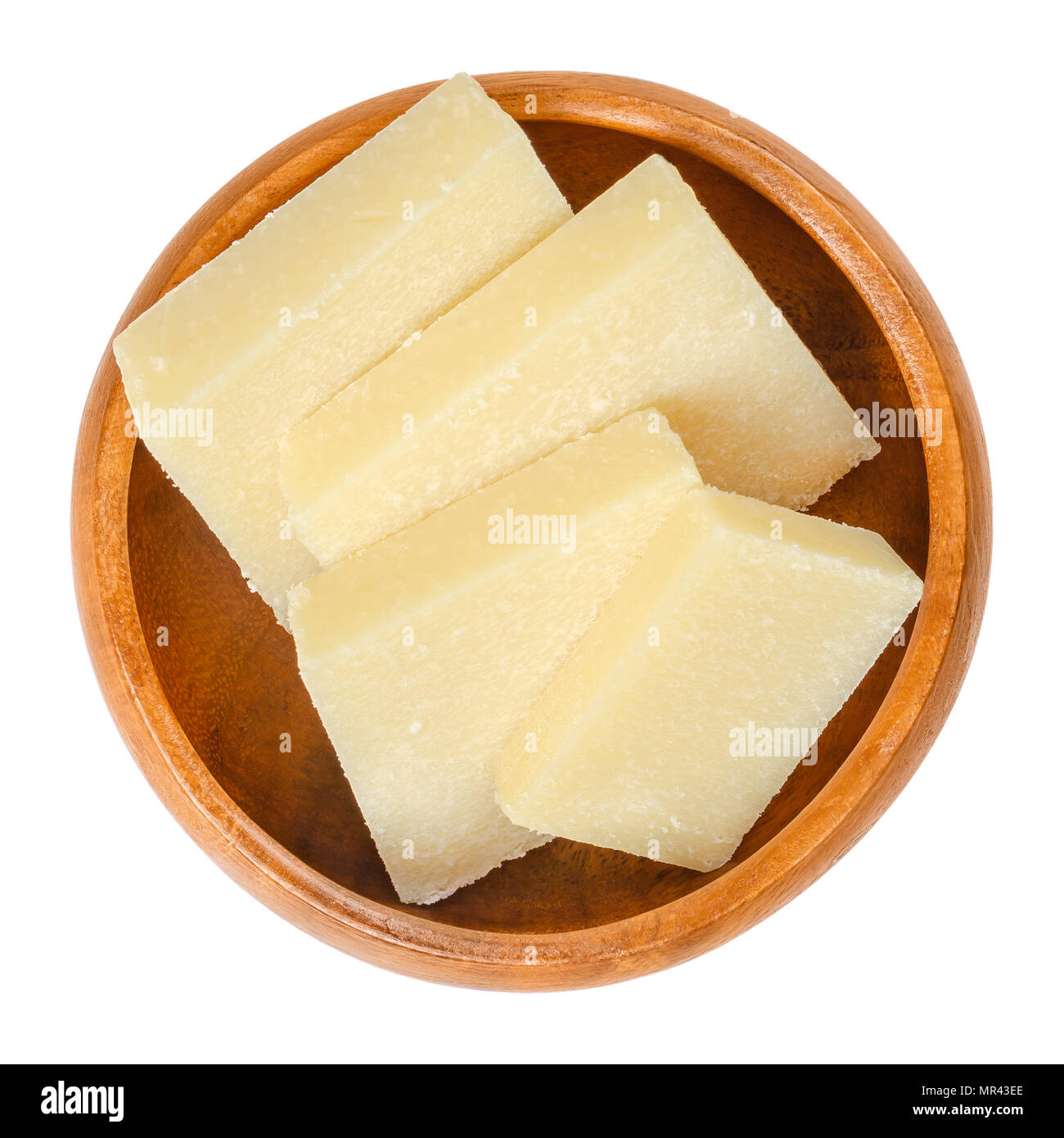 Parmesan cheese slices in wooden bowl. Parmigiano-Reggiano. Italian hard, granular cheese, of slightly yellow color, made of unpasteurized cow milk. Stock Photo
