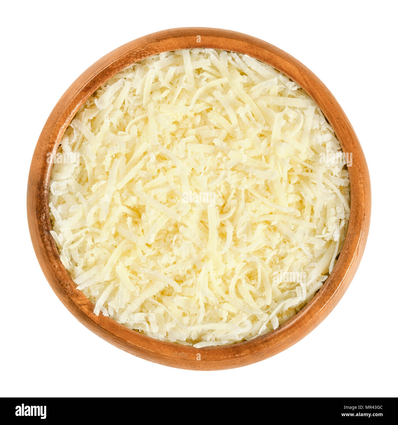 Grated Parmesan cheese in wooden bowl. Parmigiano-Reggiano. Italian hard, granular cheese, of slightly yellow color, made of unpasteurized cow milk. Stock Photo