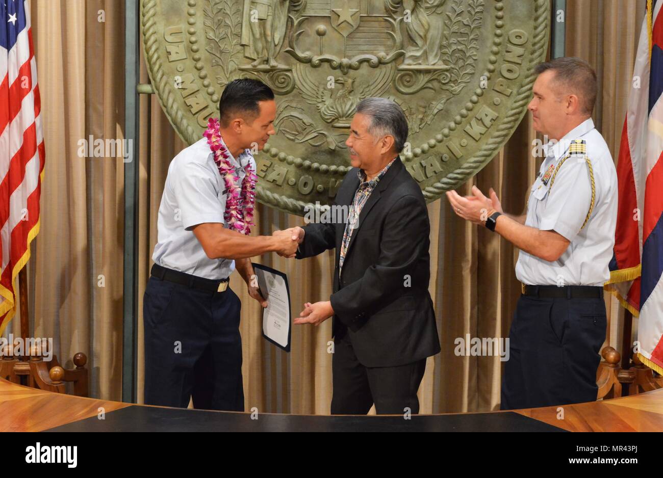 Petty Officer 2nd Class Scott Lee, a boatswain’s mate stationed at Coast Guard Station Honolulu, was recognized for his outstanding community service by Hawaii State Governor David Y. Ige and Capt. Brian Penoyer, Fourteenth Coast Guard District chief of staff, at the Hawaii State Capitol, May 5, 2017. The Military Affairs Council of the Chamber of Commerce Hawaii joined Governor Ige in a proclamation ceremony designating May as Military Appreciation Month and honoring service members from all five branches of the armed forces for their community service contributions. (U.S. Coast Guard photo b Stock Photo