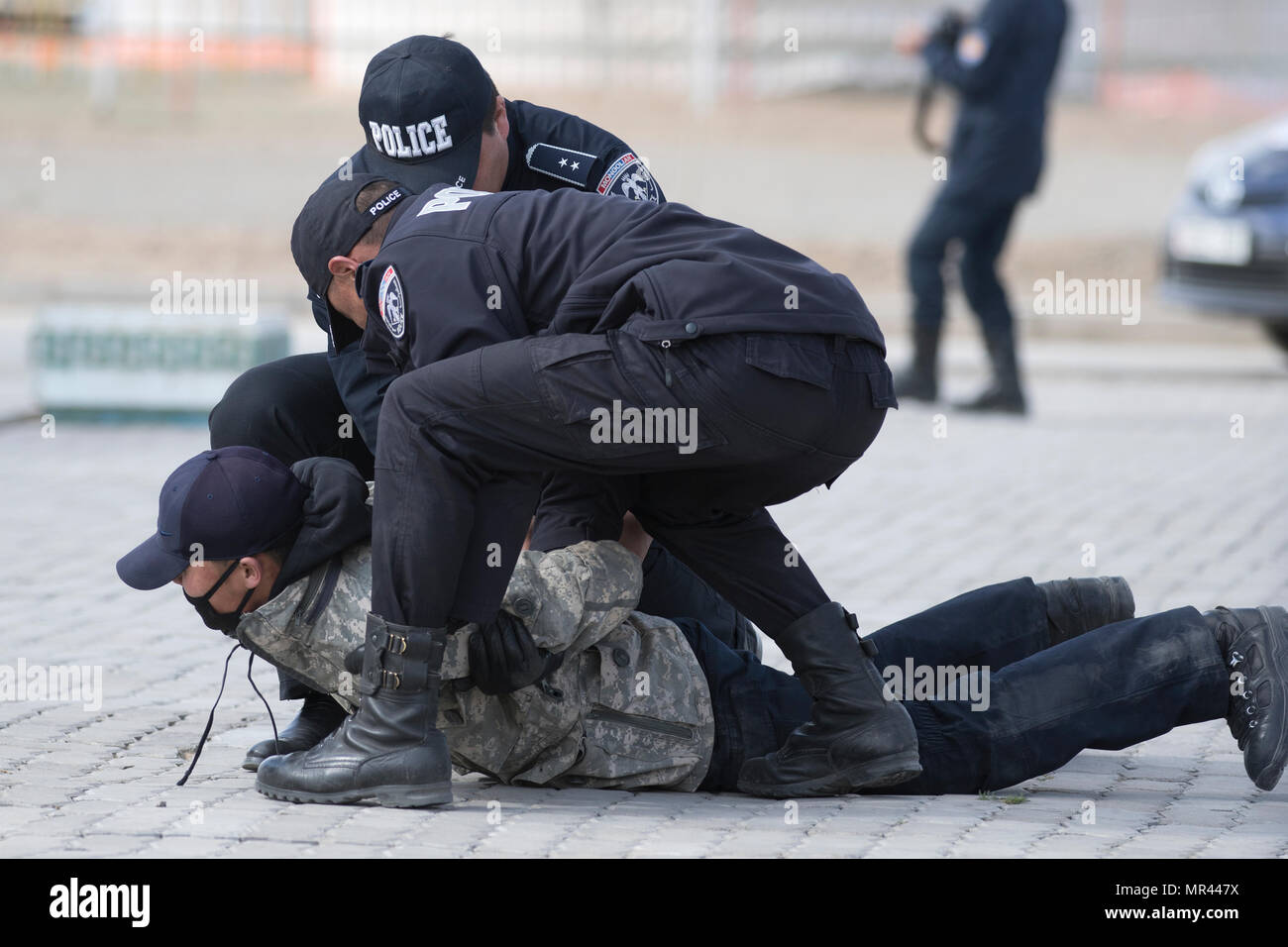 Dalanzadgad police officers apprehend a simulated looter May 4, 2017, in Dalanzadgad, Mongolia, as part of a rescue exercise during Gobi Wolf 2017. GW 17 is hosted by the Mongolian National Emergency Management Agency and Mongolian Armed Forces as part of the United States Army Pacific's humanitarian assistance and disaster relief 'Pacific Resilience' series. (U.S. Army photo by Sgt. David Bedard) Stock Photo