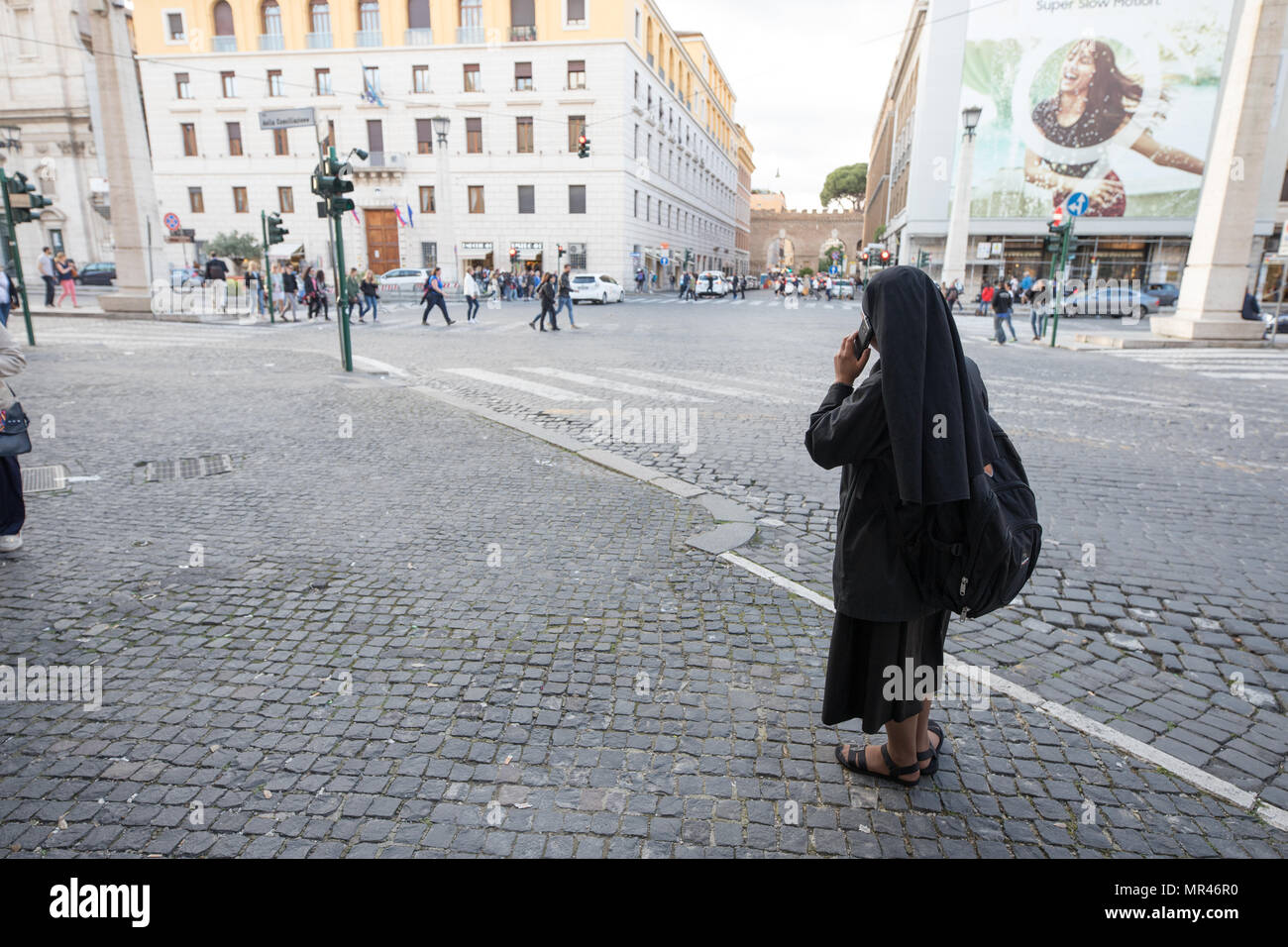 Nun phoning standing in street, Rome Italy Stock Photo