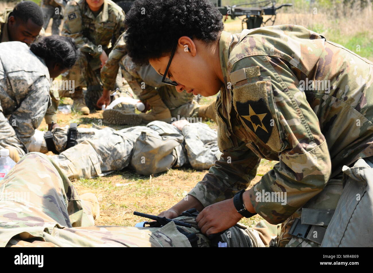 Soldiers assigned to Headquarters Support Company, 70th Brigade Support Battalion, 210th Field Artillery Brigade, 2nd Infantry Division/ROK-US Combined Division, applies a tourniquet to a simulated casualty during a field training exercise at LTA130, South Korea, May 3, 2017. The week long FTX provides Soldiers training opportunities under simulated combat conditions. (U.S. Army photo by Cpl. Michelle U. Blesam, 210th FA Bde PAO) Stock Photo