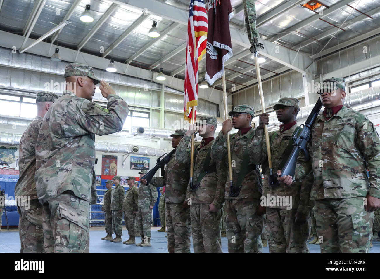Col. George Kyle, the commander of the 31st Combat Support Hospital, salutes the colors, during the transfer of authority ceremony, in the Zone 1 Fitness Center, Camp Arifjan, Kuwait, May 5. The ceremony marked the last deployment for the 31st CSH, as it will transform into a field hospital unit upon returning to the United States. (U.S. Army photo by Sgt. Bethany Huff, ARCENT Public Affairs) Stock Photo