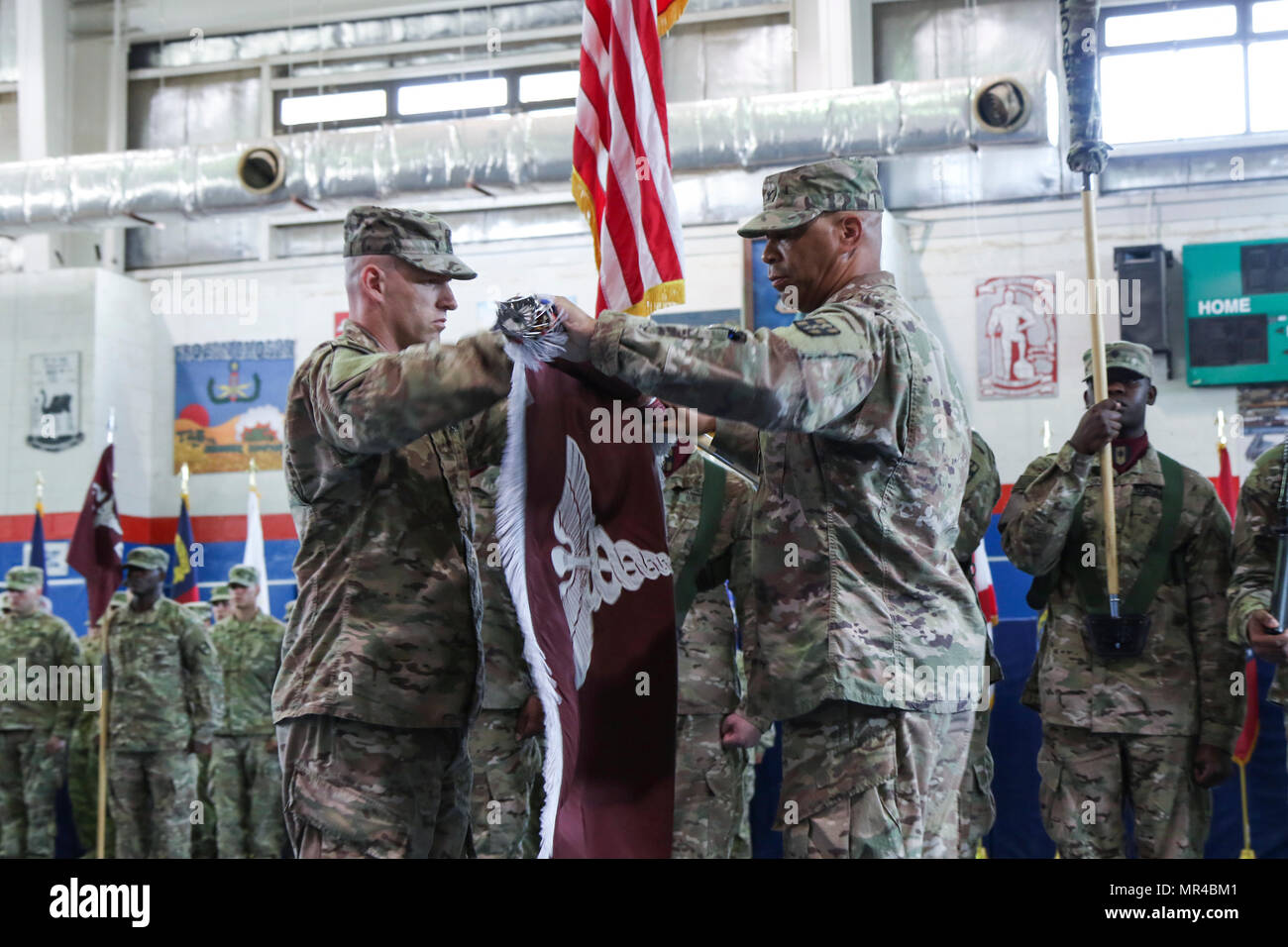 Col. George Kyle (right), the commander of the 31st Combat Support Hospital, and Command Sgt. Maj. Robert Nelson, the command sergeant major for the 31st CSH, cases the unit’s colors, during the transfer of authority ceremony, in the Zone 1 Fitness Center, Camp Arifjan, Kuwait, May 5. The ceremony marked the last deployment for the 31st CSH, as it will transform into a field hospital unit upon returning to the United States. (U.S. Army photo by Sgt. Bethany Huff, ARCENT Public Affairs) Stock Photo
