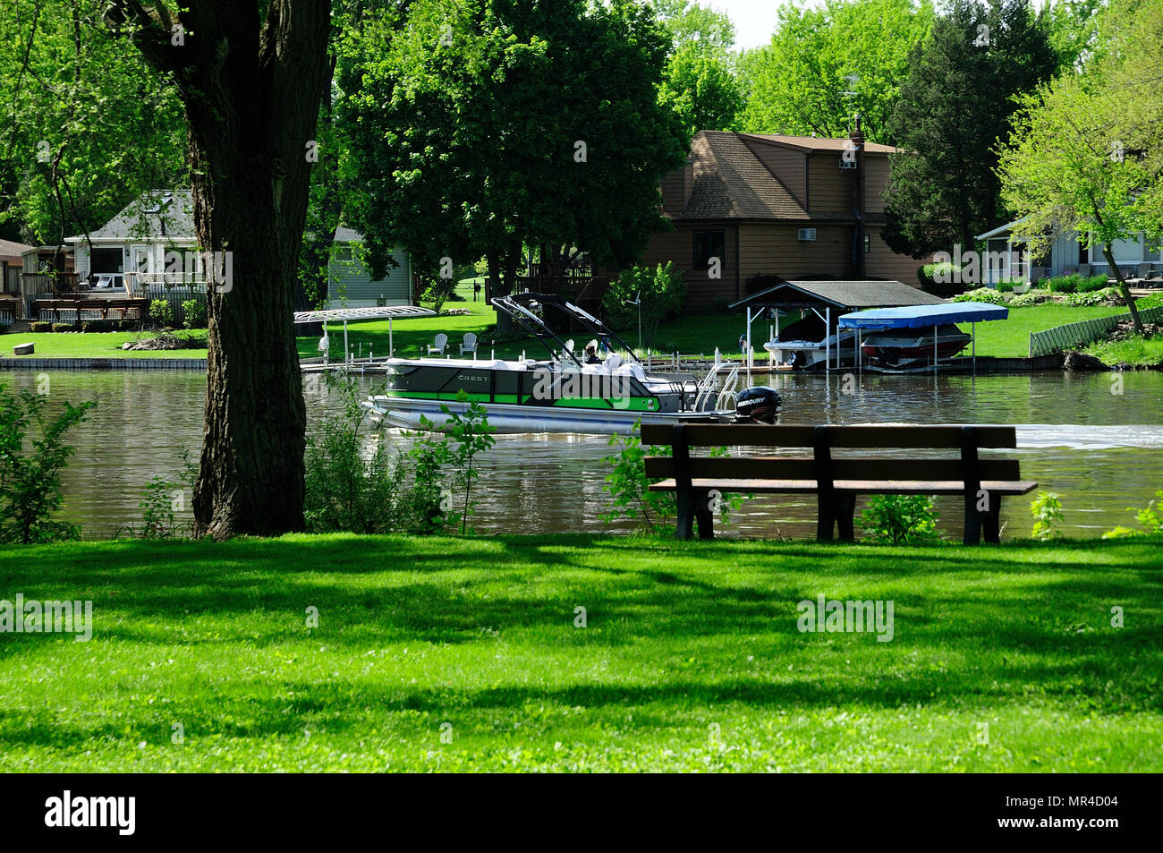 Neighborhood park with bench along Fox River in Illinois, USA. Stock Photo