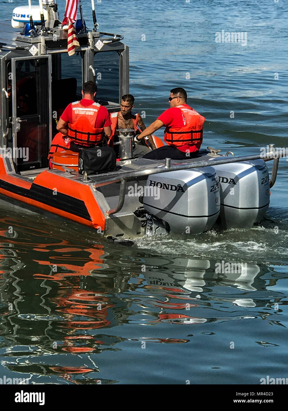 A Coast Guard 29-foot Special Purpose Craft-Shallow Water boat crew from Station Fort Myers Beach and Lee County EMS personnel are shown Tuesday, May 9, 2017 with a 28-year-old man (center) in need of medical attention aboard the SPC-SW near Estero Bay, Florida. The man was medevacked from the sailboat Anna Maria due to suffering from abdominal pain and transferred to EMS on shore in stable condition. (U.S. Coast Guard photo by Petty Officer 1st Class Shae Currington) Stock Photo