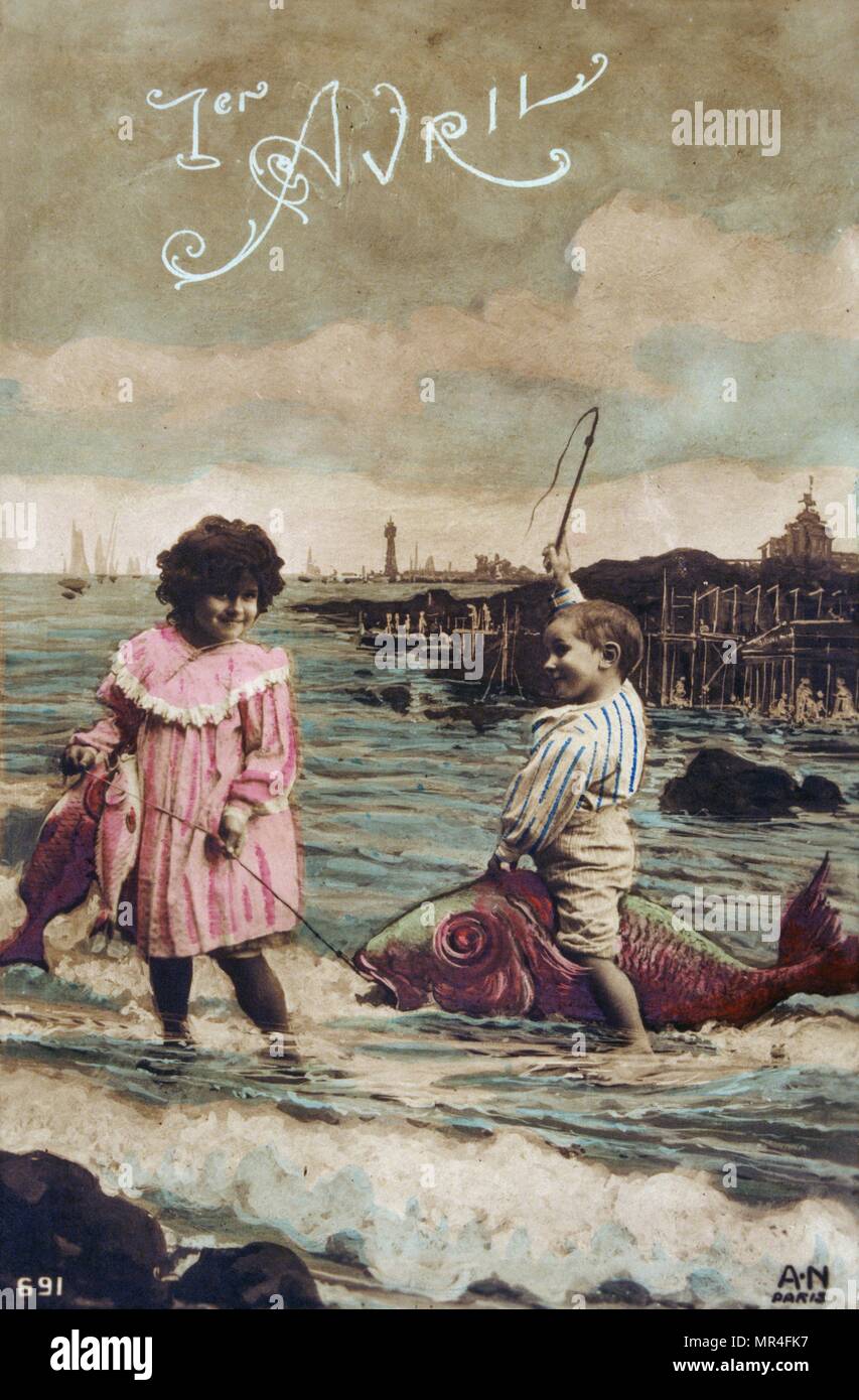 French postcard with image of a girl and boy capturing a sea fish Stock Photo