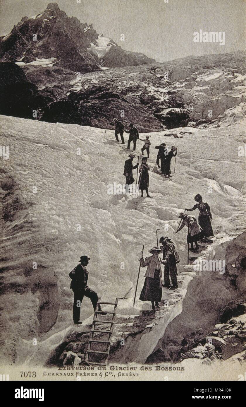 climbers (men and woman) walking across the Bossons Glacier in the Mont Blanc massif of the Alps, in the Chamonix valley of Haute-Savoie département, south-eastern France. 1900 Stock Photo