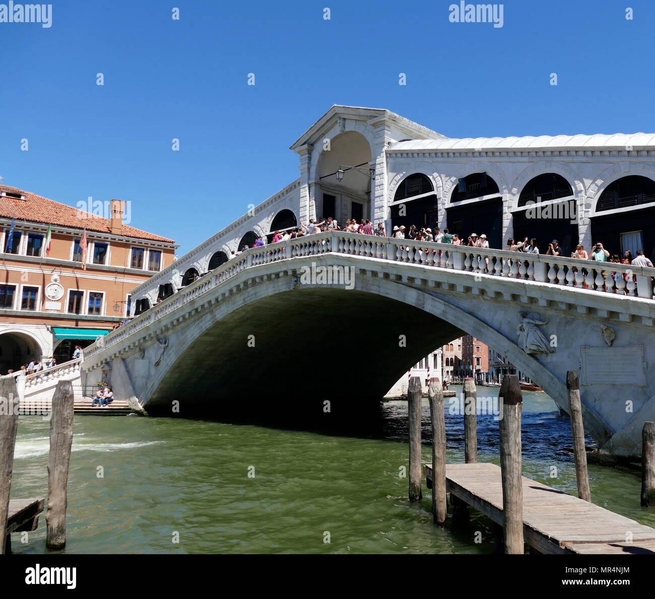 The Rialto Bridge (Ponte di Rialto), spanning the Grand Canal in Venice, Italy. It is the oldest bridge across the canal, and was the dividing line for the districts of San Marco and San Polo. The present stone bridge, a single span designed by Antonio da Ponte, was finally completed in 1591. Stock Photo