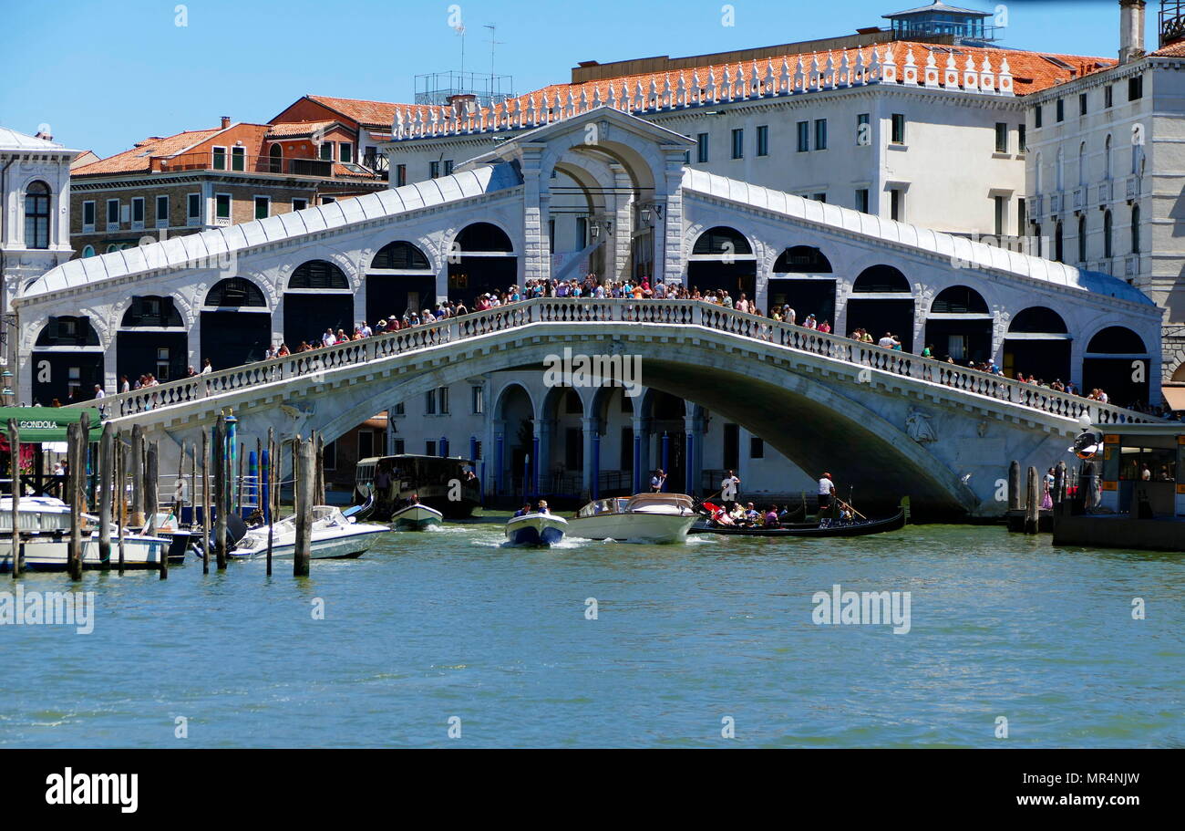 The Rialto Bridge (Ponte di Rialto), spanning the Grand Canal in Venice, Italy. It is the oldest bridge across the canal, and was the dividing line for the districts of San Marco and San Polo. The present stone bridge, a single span designed by Antonio da Ponte, was finally completed in 1591. Stock Photo