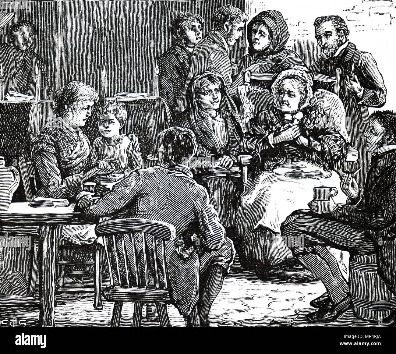 Engraving depicting an evening wake for the wife of an Irish cottager. Friends and relations and neighbours gather round the women's coffin to mourn. Dated 19th century Stock Photo