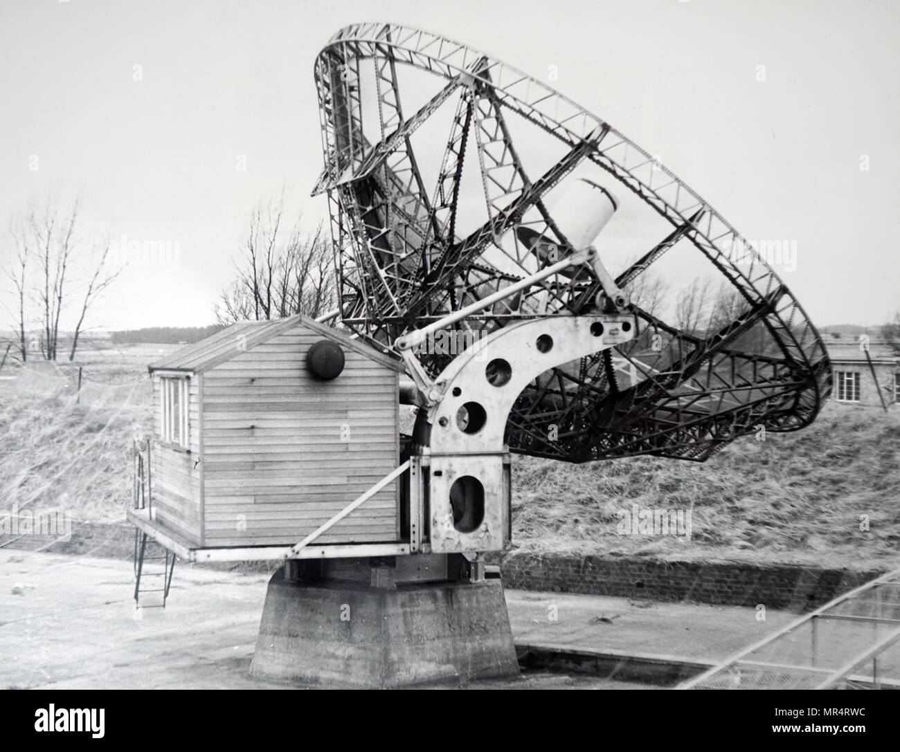 Photograph of a steerable paraboloid with reflecting netting on the ground, constructed from World War Two radar equipment, located at the Mullard Radio Astronomy Observatory. Dated 20th century Stock Photo