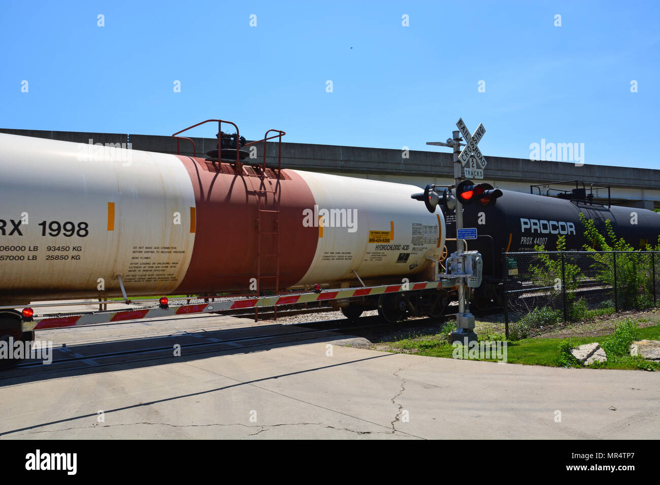 Rail tanker cars carrying corrosive hydrocloric acid pass through a Chicago south side neighborhood. Stock Photo