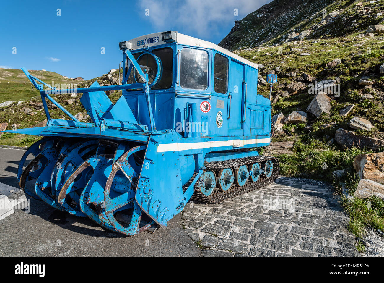 Blue snow blower in the mountain against blue sky Stock Photo Alamy