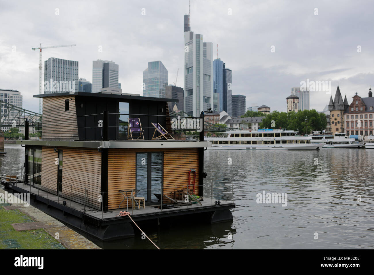 The houseboat of Leo Oswald is moored at the quays at the river Rain, opposite downtown Frankfurt, with the Frankfurt Skyline in the background. 4 new episodes of the relaunch of the long running TV series 'Ein Fall fuer zwei’ (A case for two) are being filmed in Frankfurt for the German state TV broadcaster ZDF (Zweites Deutsches Fernsehen). It stars Antoine Monot, Jr. as defence attorney Benjamin ‘Benni’ Hornberg and Wanja Mues as private investigator Leo Oswald. The episodes are directed by Thomas Nennstiel. The episodes are set to air in October. (Photo by Michael Debets / Pacific Press) Stock Photo